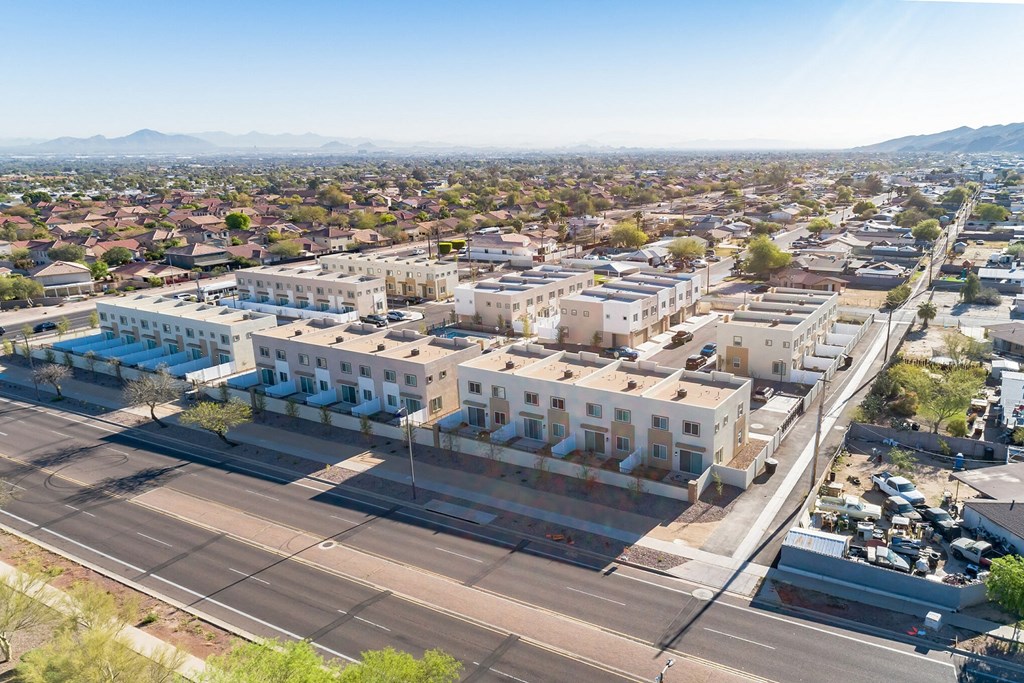 an aerial view of a city with buildings and a street