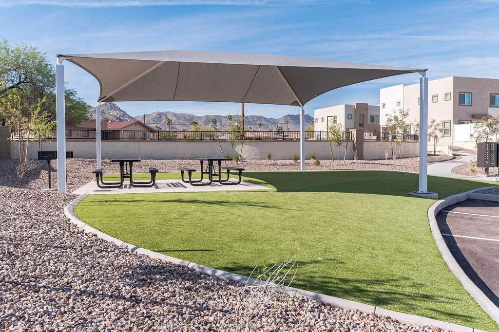 a park with picnic tables under a canopy
