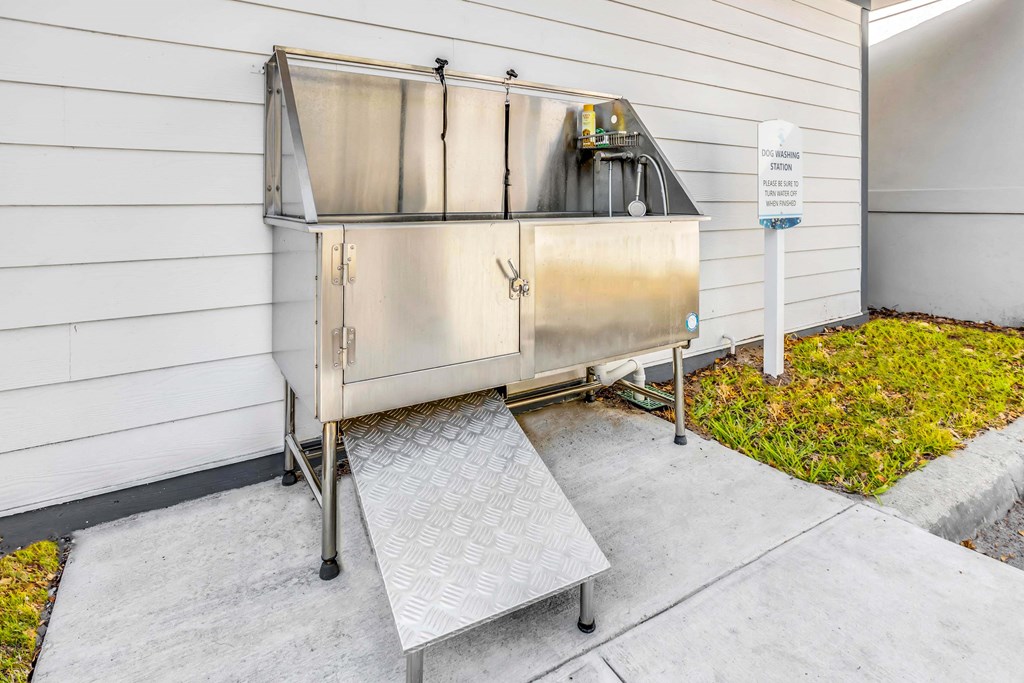 a stainless steel barbecue grill on the side of a building