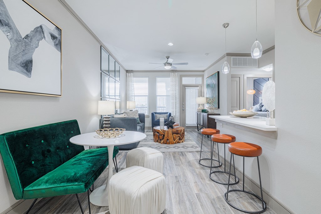 a living room with a table and stools