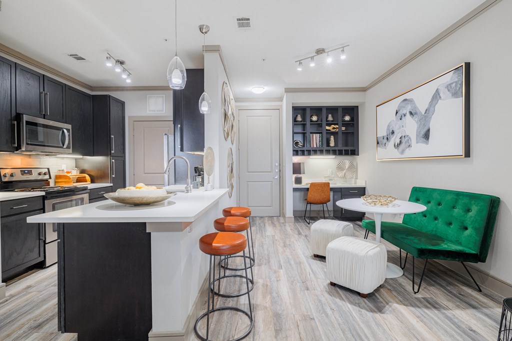 a kitchen and living room with an island and stools