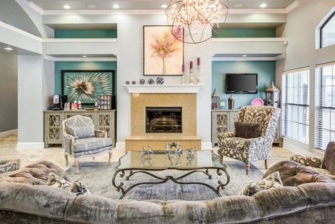 A living room with a fireplace and a chandelier.