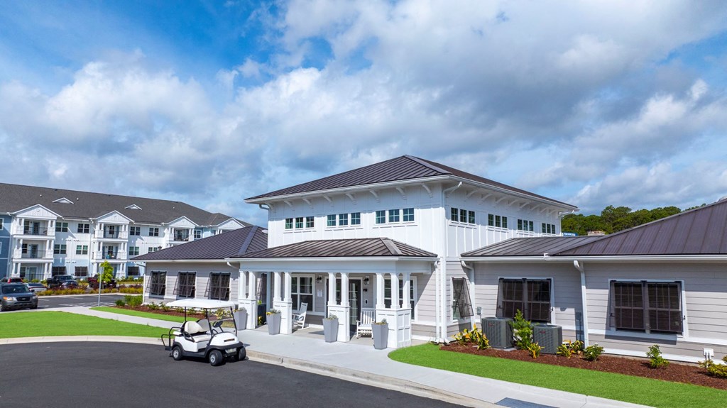 a large white building with a golf cart parked in front of it