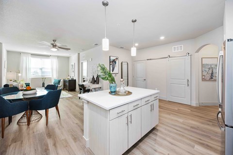 A kitchen with a dining table and chairs.