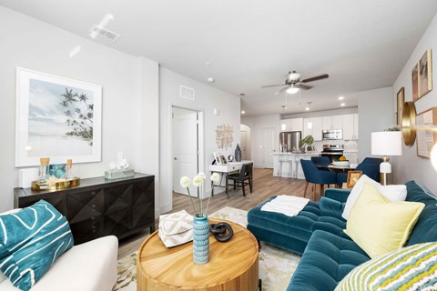 A living room with a white couch and a blue couch.