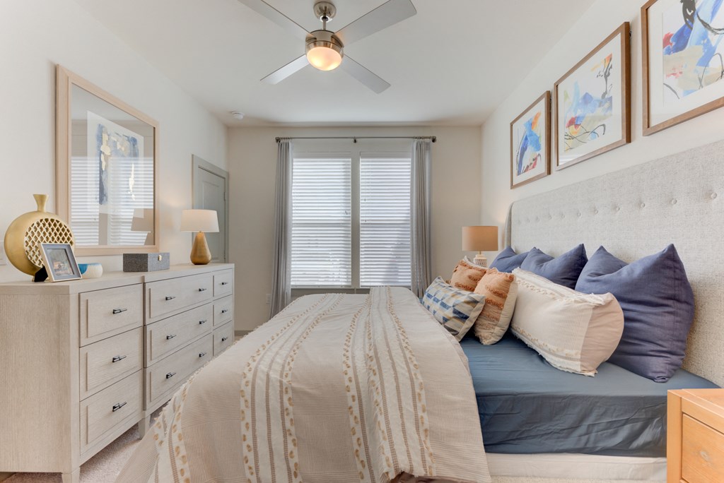 a bedroom with a bed and a ceiling fan
