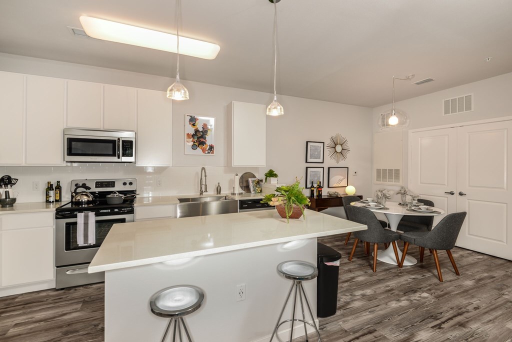 A modern kitchen with a large island and bar stools.