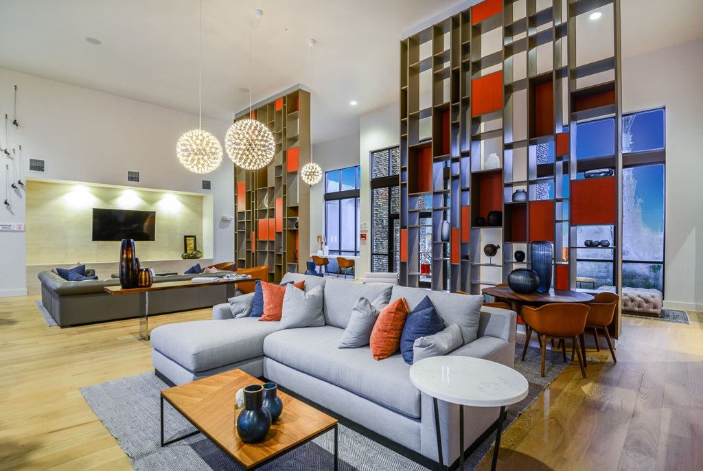 A modern living room with a grey sofa and a wooden coffee table.