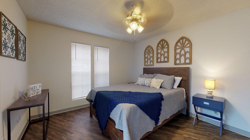 a bedroom with a bed and a nightstand and a window