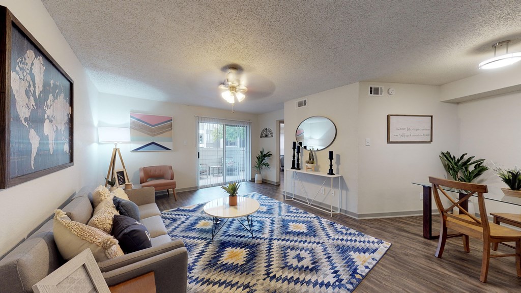 a living room with a blue and white rug and a couch