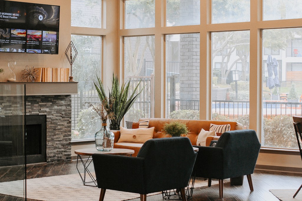 a living room with a couch and chairs and a fireplace
