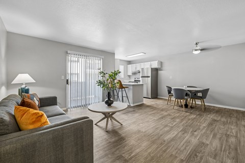 A living room with a grey couch and a coffee table.