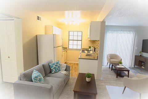 A living room with a grey couch and a wooden coffee table.