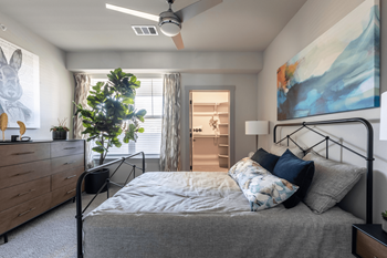 a bedroom with a bed and a ceiling fan
