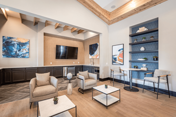 a living room with couches and chairs and a television