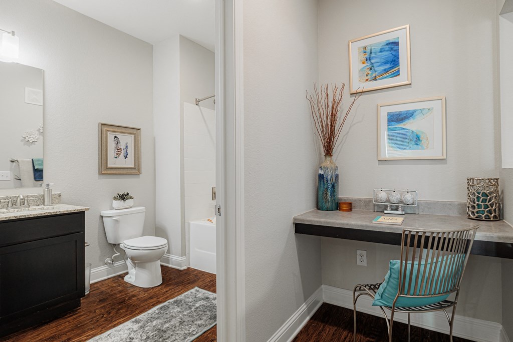 a bathroom with a toilet and a sink and a chair