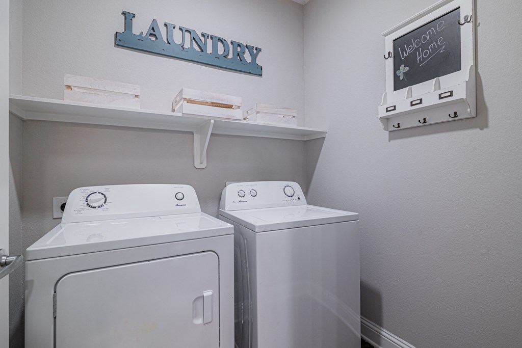a laundry room with two washes and a dryer