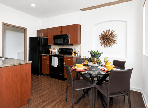 A kitchen with a table set for two.