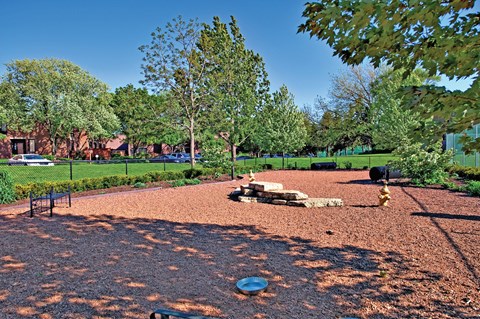 A playground with a red surface and a blue frisbee.