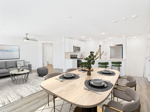 A modern dining room with a large table set for six.