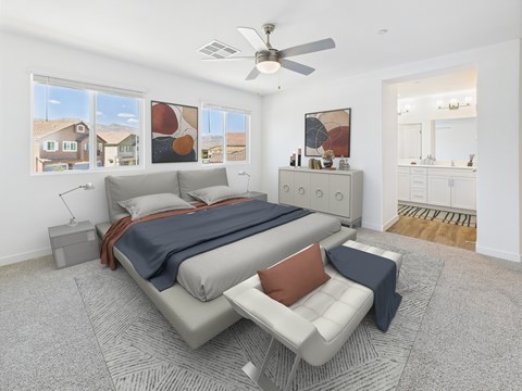 A bedroom with a bed, a chair, and a ceiling fan.