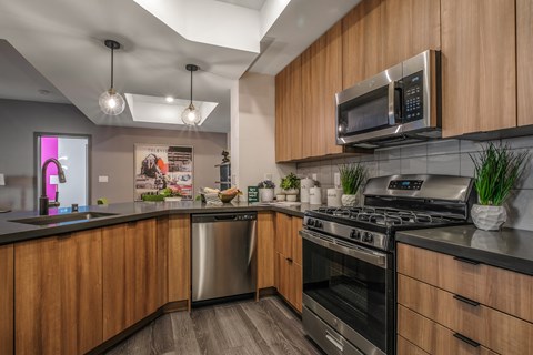 a kitchen with stainless steel appliances and wooden cabinets