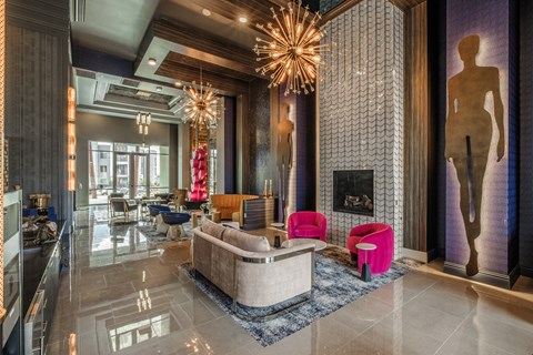 a lobby with couches and chairs and a fireplace