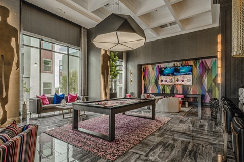 a living room with a ping pong table in the middle