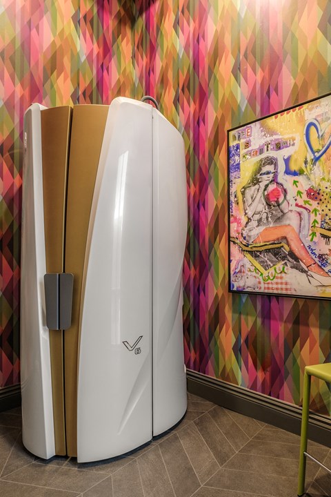 two surfboards on display in a room with a colorful wall