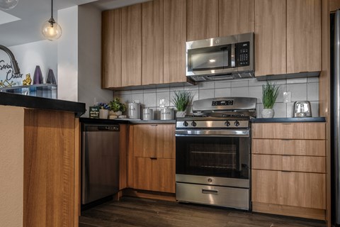 a kitchen with stainless steel appliances and wooden cabinets