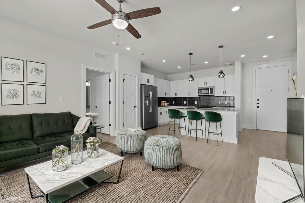 A modern living room with a green sofa and a coffee table.
