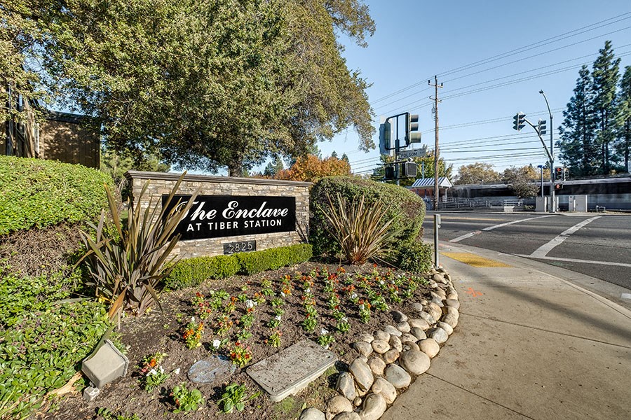 the enclave at their sign on the corner of a street