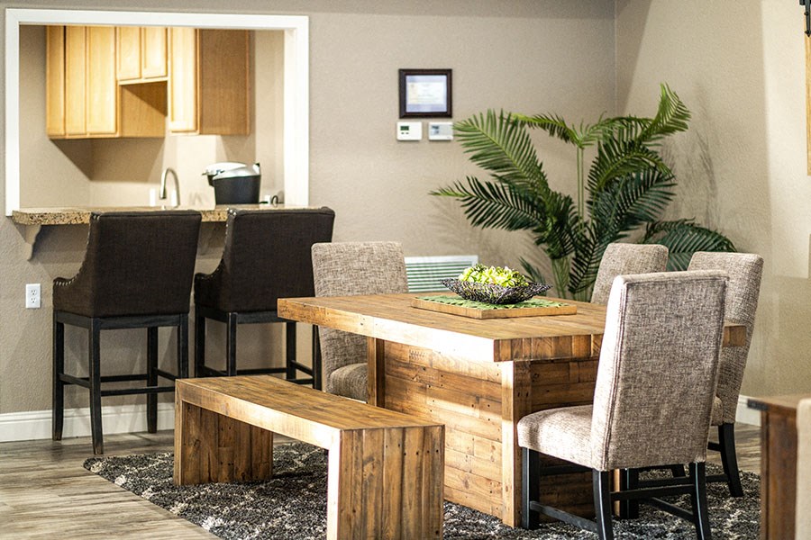 a dining room with a wooden table and chairs