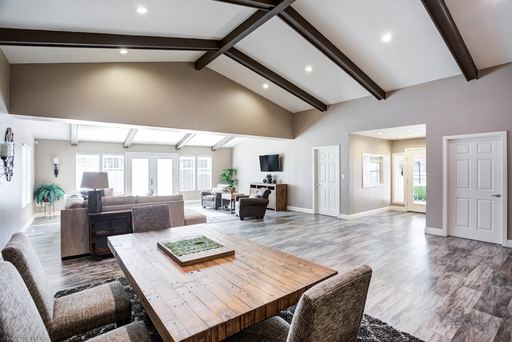 A large, modern dining room with a wooden table and chairs.