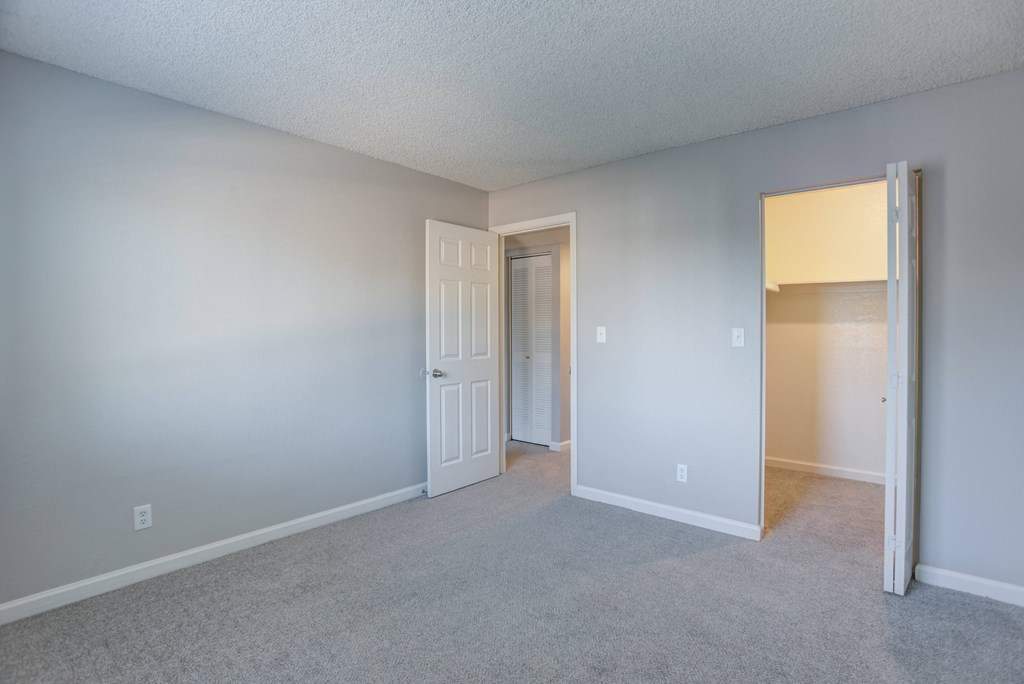 A room with a carpeted floor and white walls.