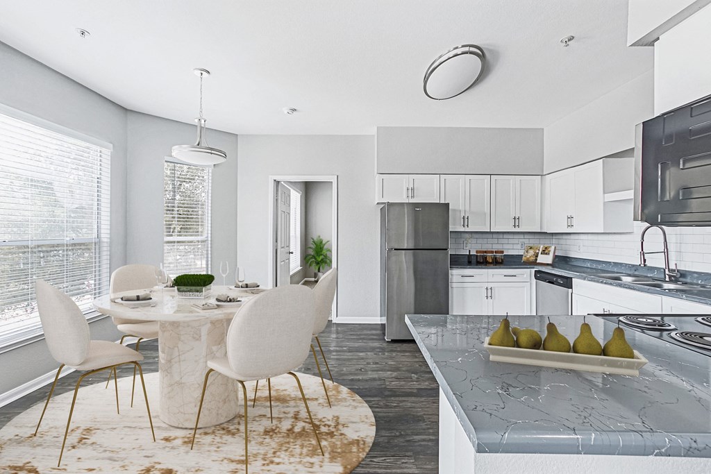 an open kitchen and dining room with a table and chairs