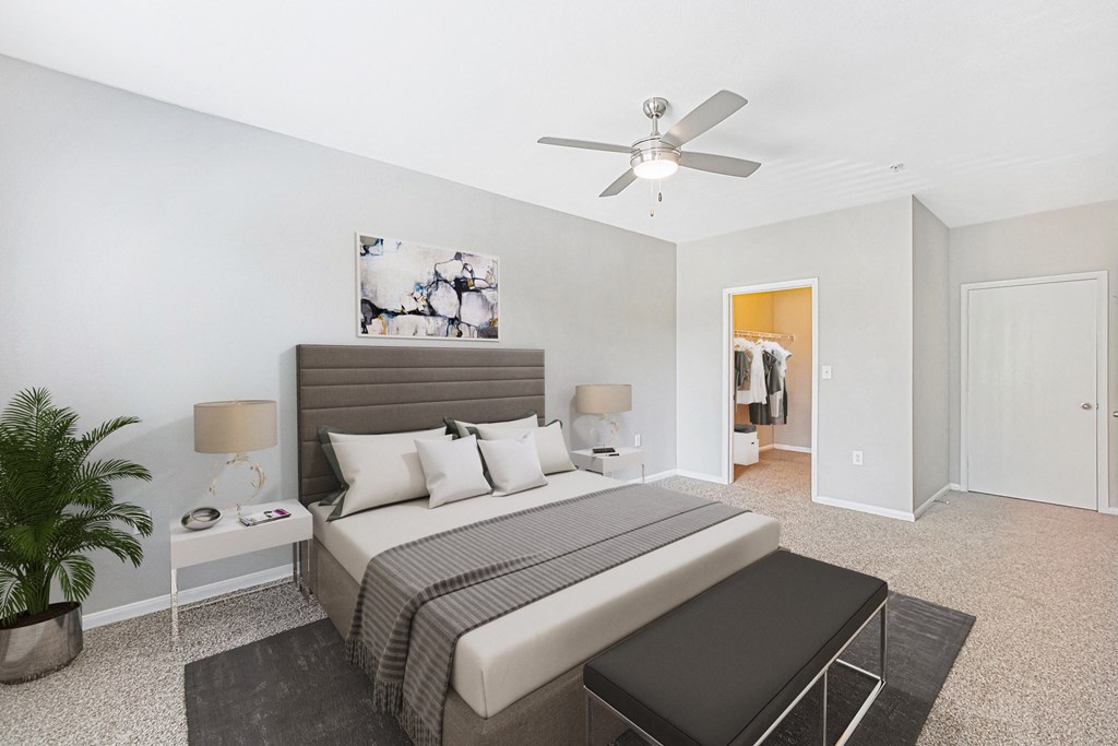 a bedroom with a bed and a ceiling fan