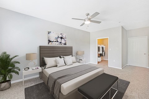 a bedroom with a bed and a ceiling fan