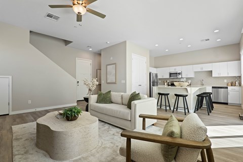 A modern living room with a white couch and a concrete coffee table.