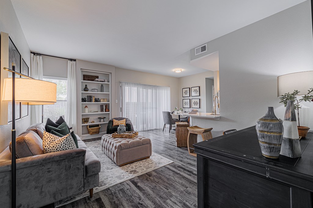 spacious living room with couches and chairs and a dining room table