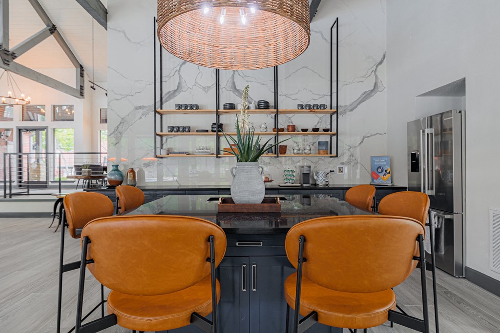 a dining area with a table and chairs and a large window