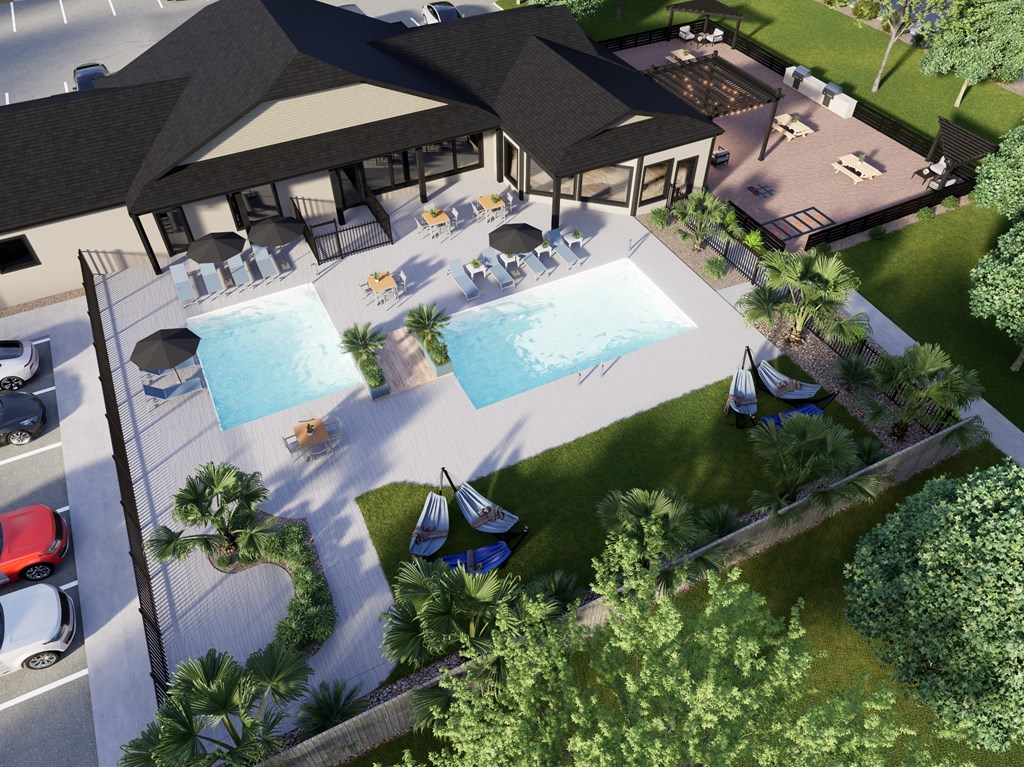 A pool area with a gazebo and lounge chairs.