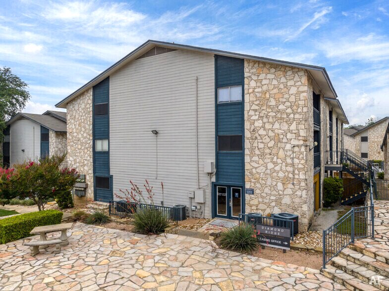 a house with a stone facade and a picnic table in front of it