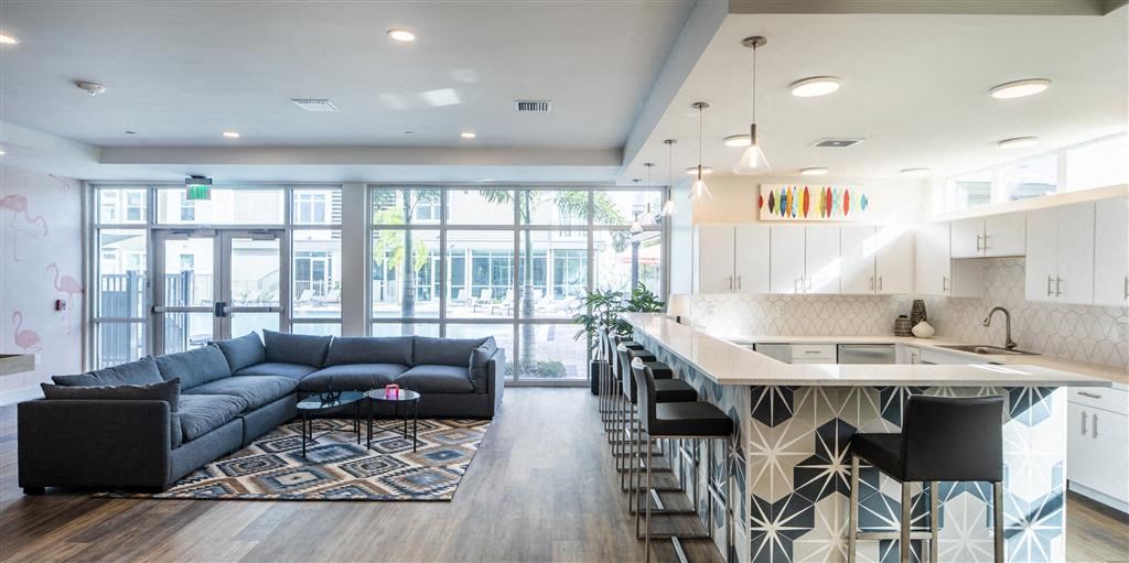 a living room with a kitchen and a couch