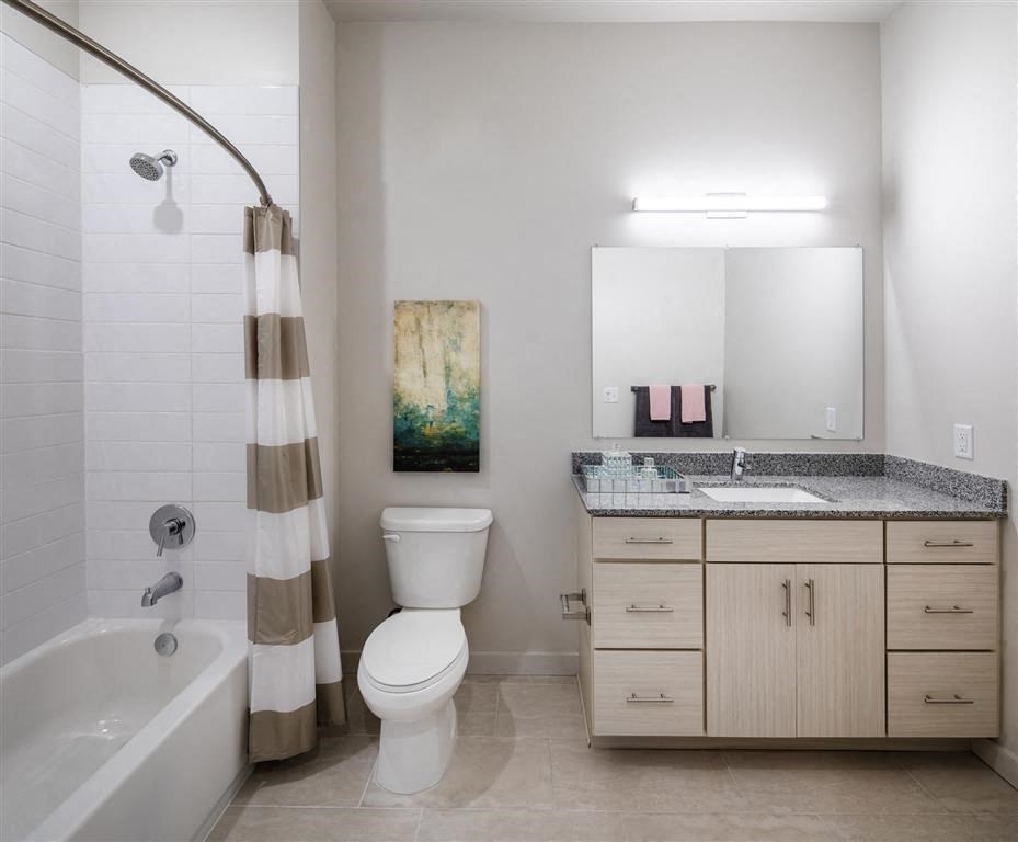a bathroom with a toilet sink and bath tub
