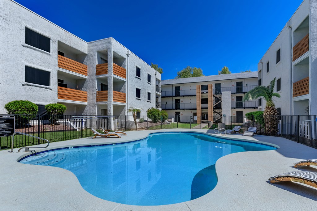 a swimming pool in front of an apartment building