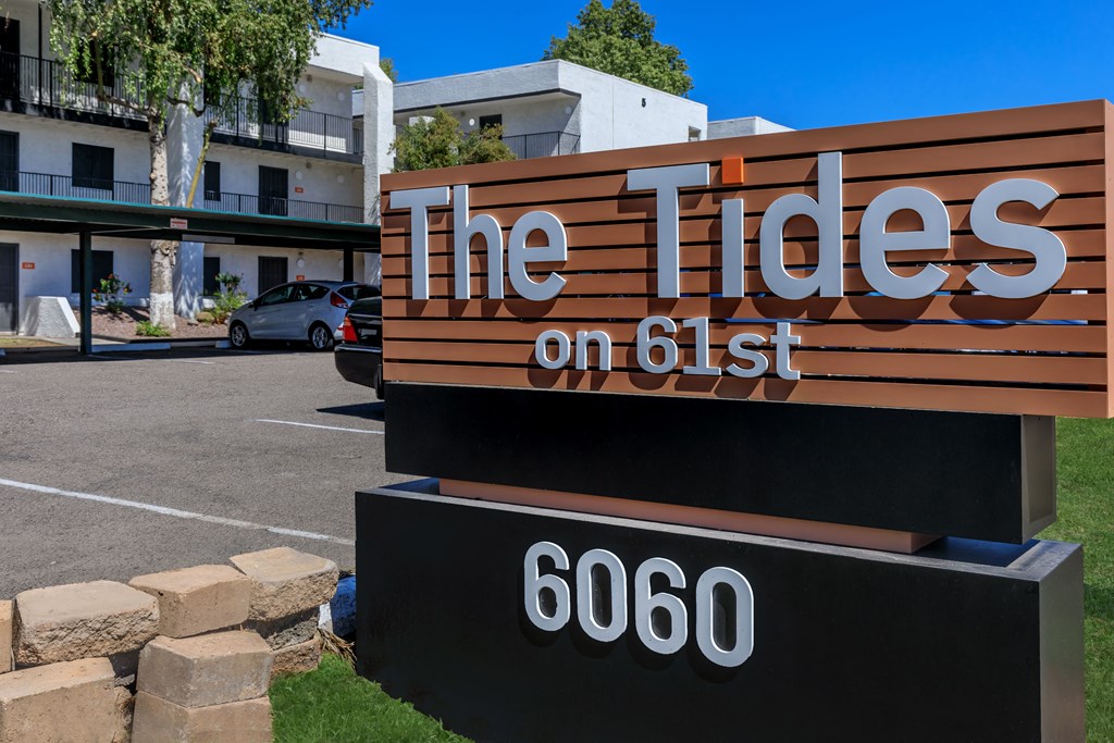 a sign for the tides on 651 in front of a building