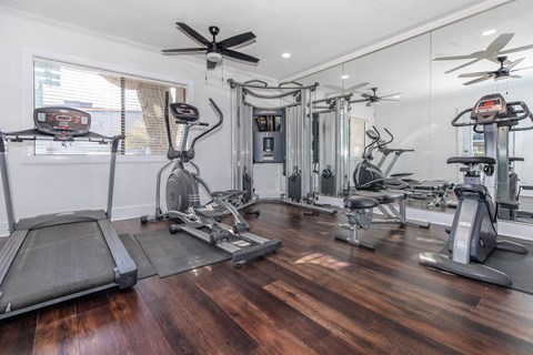 A spacious home gym with a variety of exercise equipment.