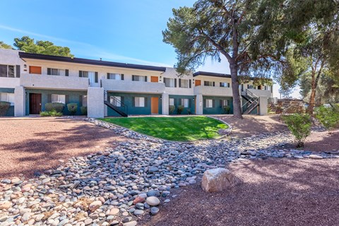 A building with a green lawn in front of it.