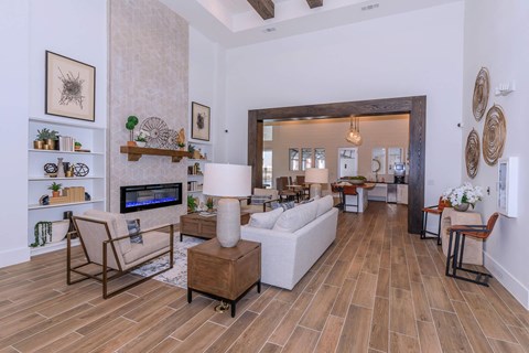 A living room with a white couch and a wooden floor.